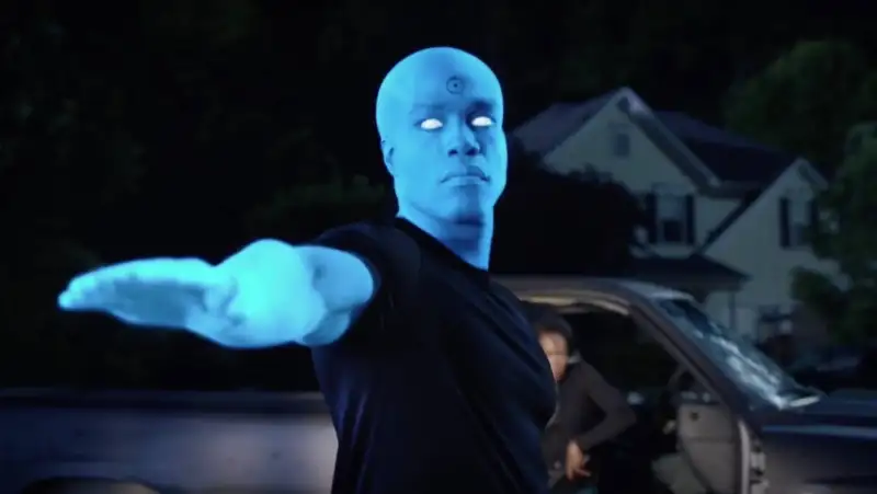 Dr. Manhattan close-up from HBO Watchmen series with glowing blue skin showing his godlike detachment